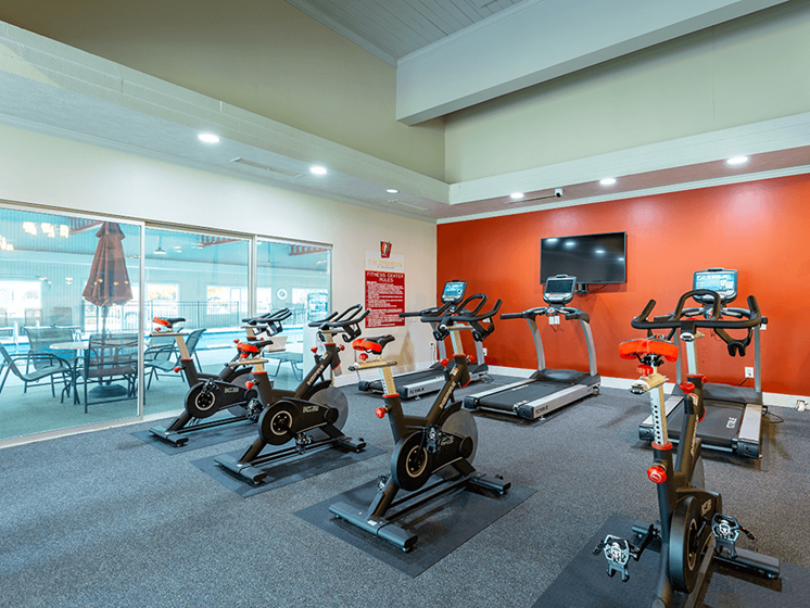 spacious on-site fitness center with lots of machines and weights